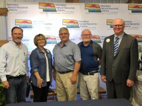 Jerry Milner (Ron Milner’s (NRD Staff inductee’s son), Debora Hefkett (Ron Milner’s daughter), Keith Rexroth (NRD Board Member inductee), Don McCabe (NRD Supporter inductee), Larry Reynolds (Nebraska Association of Resources Districts President)